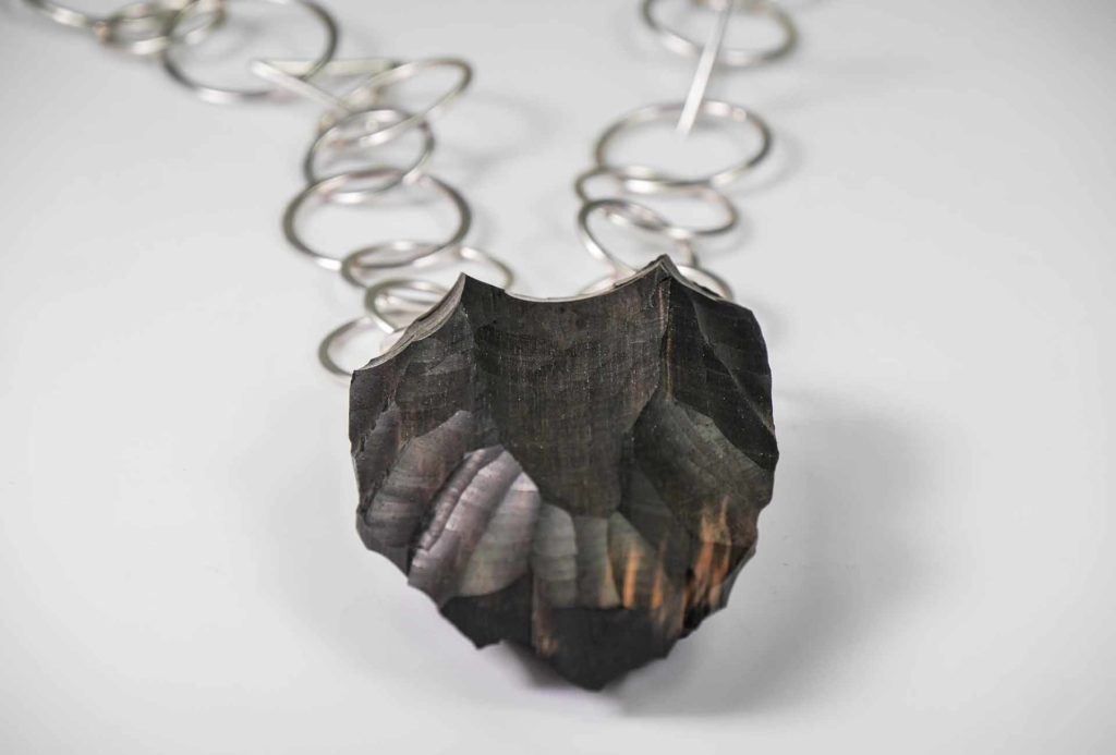 <em>Origin 3</em> pendant, 2018. Silver, ebony. Photo Harald Müller-Dempf.