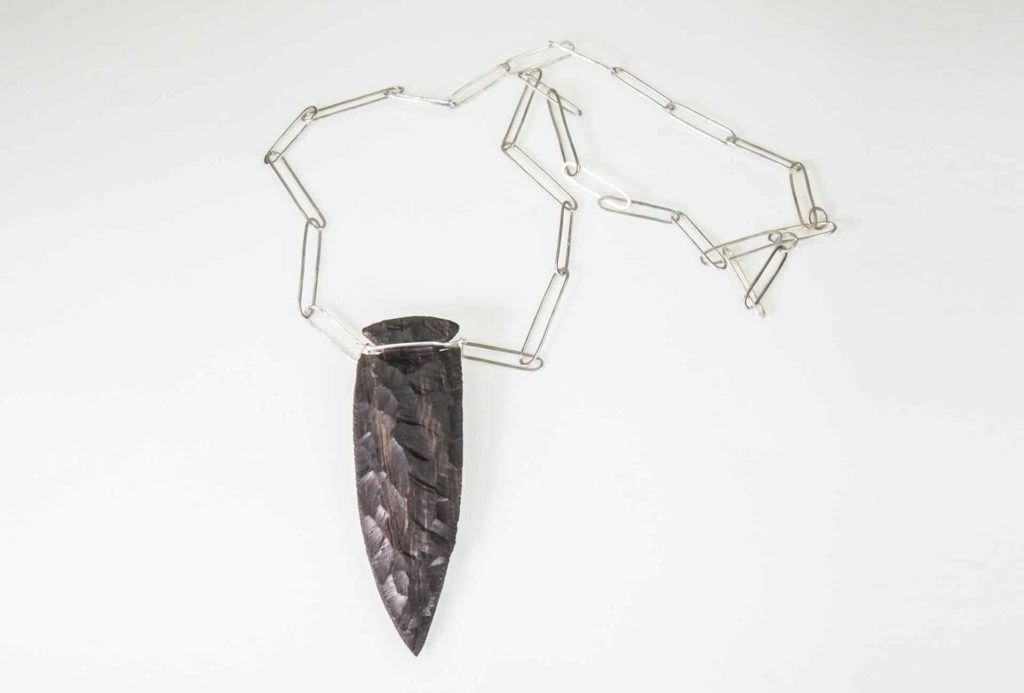 <em>Origin 4</em> pendant, 2018. Silver, ebony. Photo Harald Müller-Dempf.