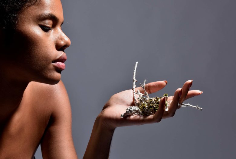 Celine O'Neal, brooch <em>Natural Affinity</em>. Fairmined silver, porcelain, plants, earth, glass. Her three brooches and a chain refer to the symbiotic system of men and nature. Photos Petra Jaschke / model Celine O'Neal.