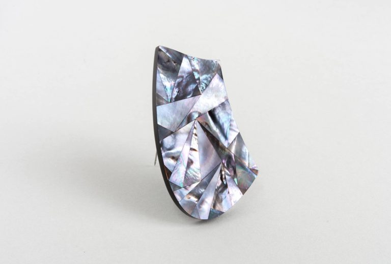 Jiro Kamata, <em>mother – love</em> brooch. Mother-of-pearl, Corian, 935 silver, stainless steel.